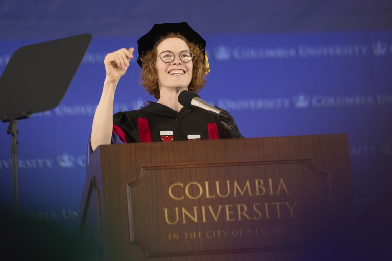 Woman in academic regalia at podium