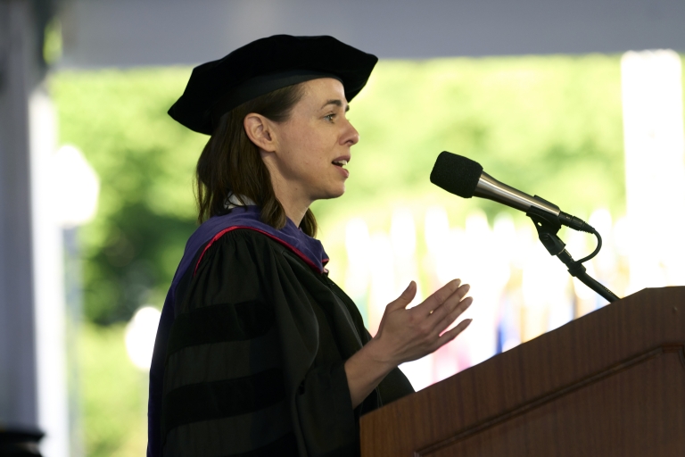 Woman in academic regalia at podium