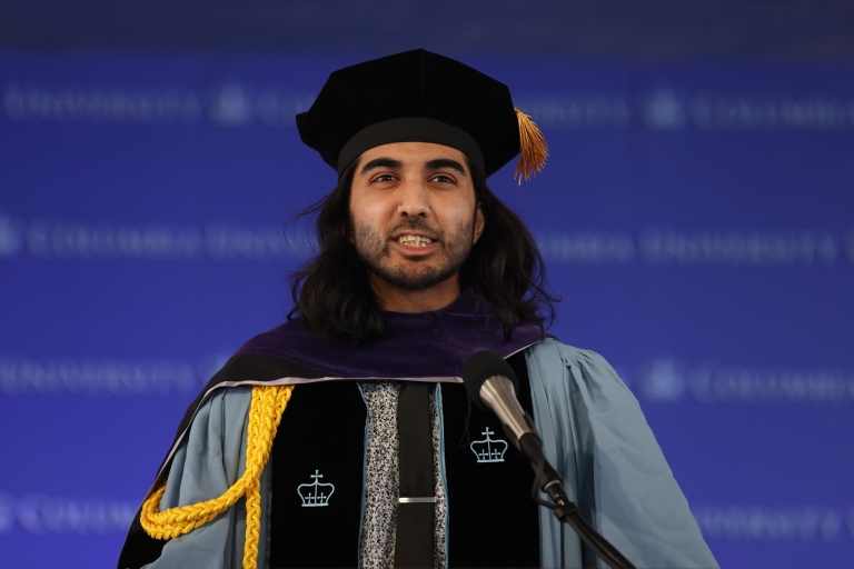 Man in academic regalia at podium