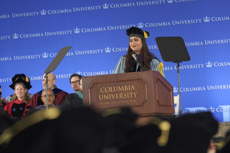 Woman in academic regalia at podium