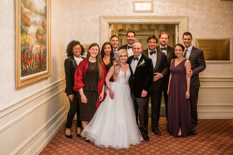 Couple in formal wedding attire with friends