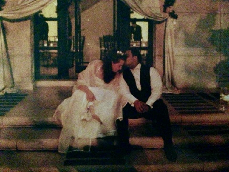 Anne Voigts and Troy Foster embracing at their wedding