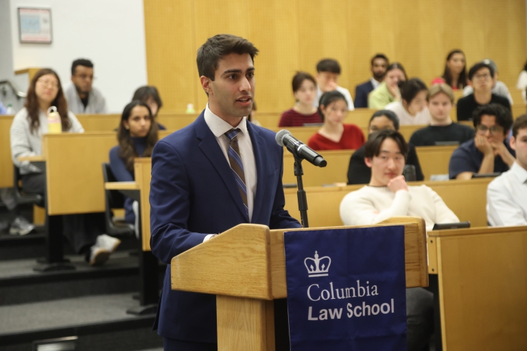 A man stands at a podium