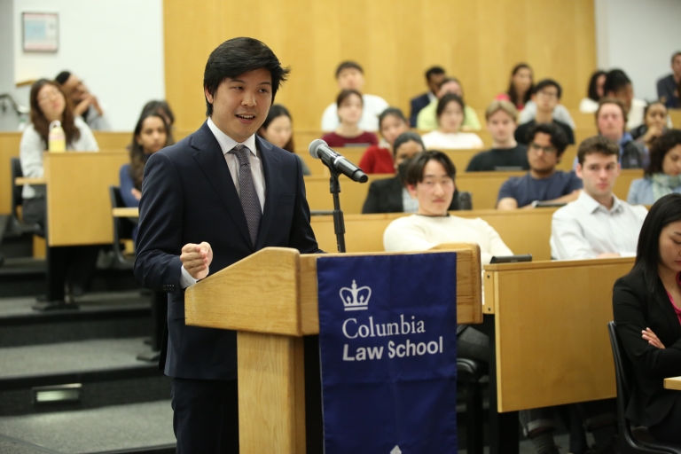 A man stands at a podium