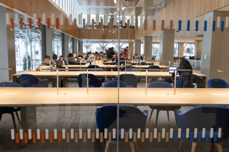 Looking through a window into a room with tables and chairs