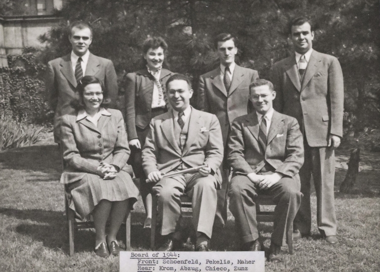Black and white photo of seven men and women law students in business clothes