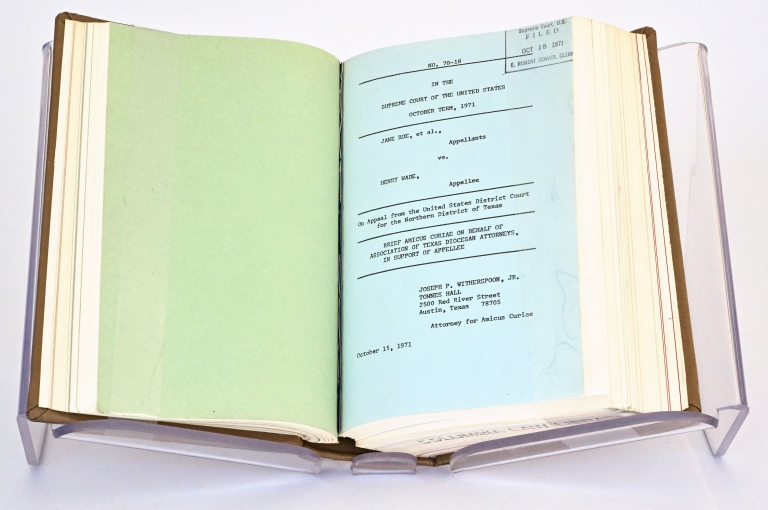 Book of Supreme Court briefs open to show first page of Roe v. Wade