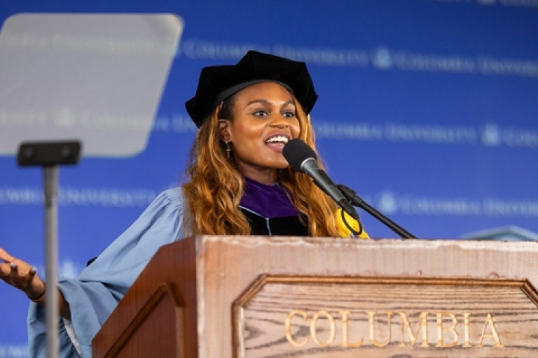 Mary M. Suberu in academic regalia at a podium