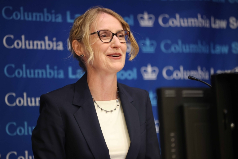 Michelle Wilde Anderson, Stanford Law School, speaks at a podium.
