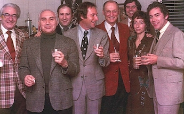 Group of men and one woman with drinks