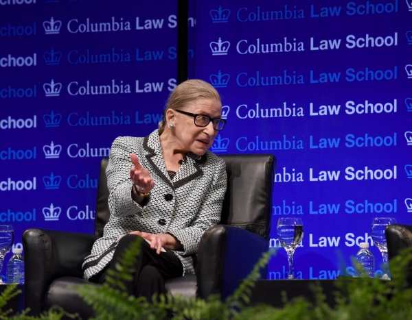 Ruth Bader Ginsburg sitting in front of Columbia Law School step and repeat
