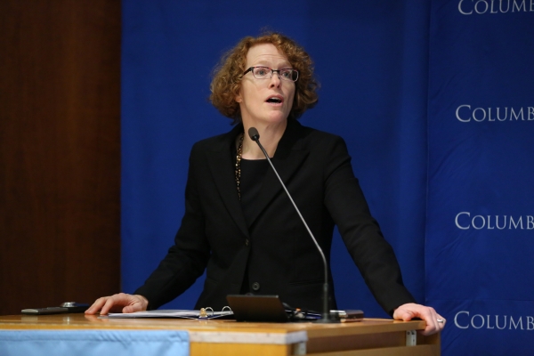 Dean Gillian Lester speaks at a podium at the 2015 Clinics Celebration