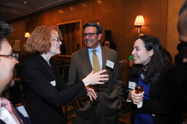 Dean Gillian Lester enjoying a conversation with Rolando T. Acosta '82, an associate justice for the New York State Supreme Court, and Zila Reyes Acosta-Grimes '15