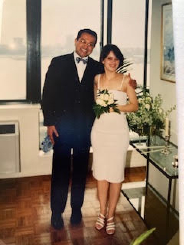  Bal Das  in bow tie and Valérie Demont in bare shouldered dress in front of a window