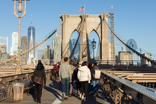 Students in the Contracts classes of Professor Eric Talley and Visiting Professor Julian Arato begin their early morning walk across the Brooklyn Bridge