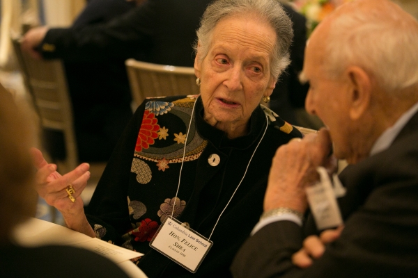 Woman and man with gray hair talking to one another