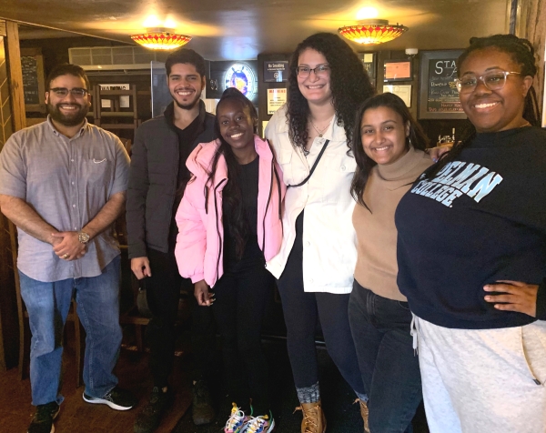 A group of six students in casual clothes smiling at the camera  