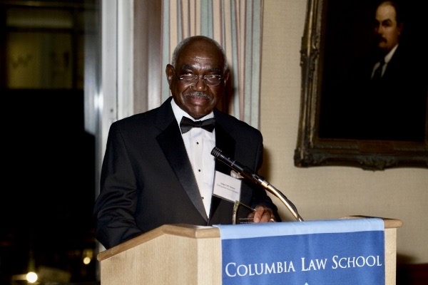 Man in tuxedo behind podium