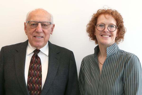 older man in suit and tie with woman in glasses