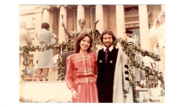 Woman in dress and man in graduation robe