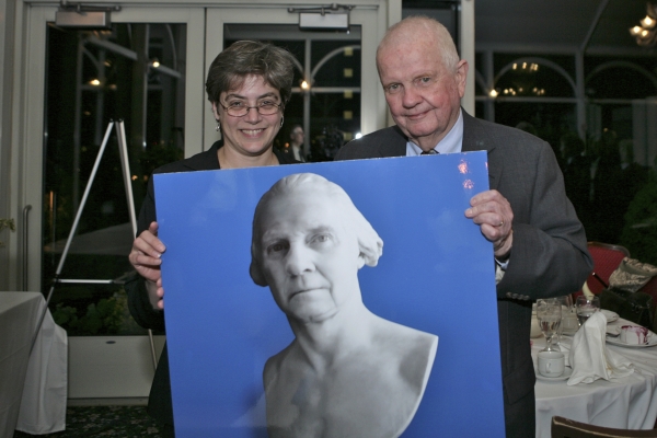 Gillian Metzger and Henry Monaghan with a poster of him as a founding father