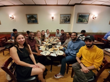 Human Rights Clinic students and New York-based activists and partners posing in front of a table with Yemeni food.