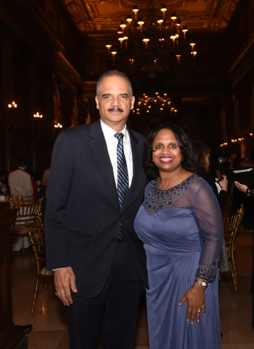 Former Attorney General Eric Holder in a suit and tie with City Bar president Sheila Boston in a lavender dress.
