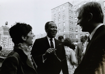 Two men and a woman laughing together. 