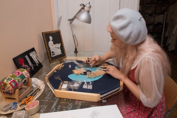 Elena Kanagy-Loux at her desk constructing the lace collar for Ruth Bader Ginsburg