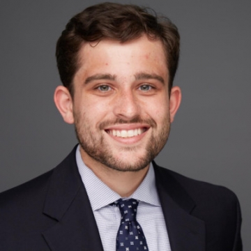 head and shoulders portrait of a young man with a beard 