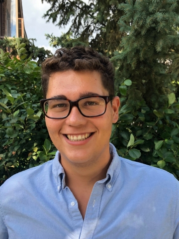 Columbia Law student Louis Enriquez-Serano ’22 in eyeglasses and blue shirt