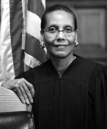 Judge Sheila Abdus-Salaam BAR ’74, LAW ’77 stands in front of an American flag.