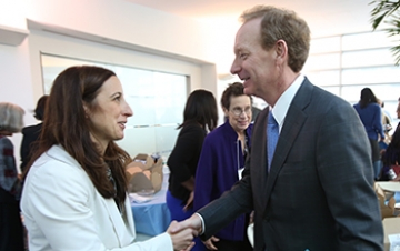 Brad Smith and Professor Alex Carter shake hands