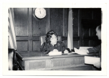 Judge Elreta Alexander in black judge's robe behind the bench in a courtroom