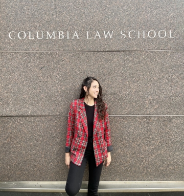 Ali Jimenez in front of a wall that says "Columbia Law School"