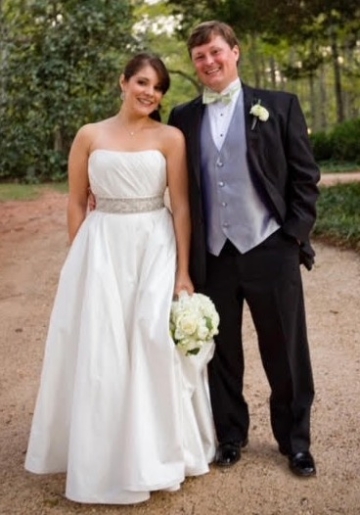 Bride in bare shoulder wedding gown and groom in formal attire