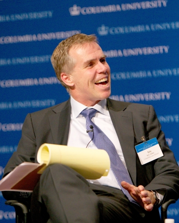 Professor Eric Talley smiles while a yellow legal pad rests on his knee