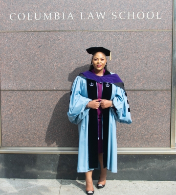 Tosin Owoka ’22 LL.M. in her graduation robe in front of Jerome Greene Hall