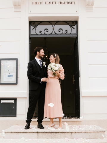 Man in suit and woman in peach dress after getting married