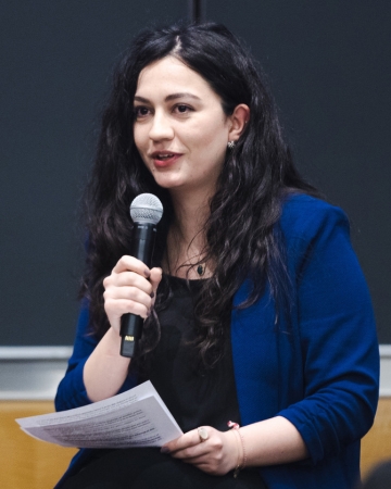 Woman in blue jacket with microphone