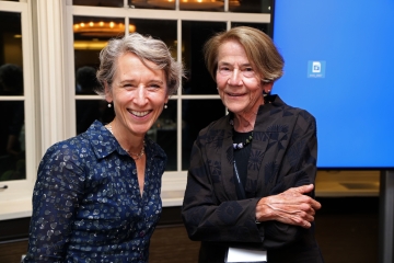 Blonde woman and brown haired woman smiling 