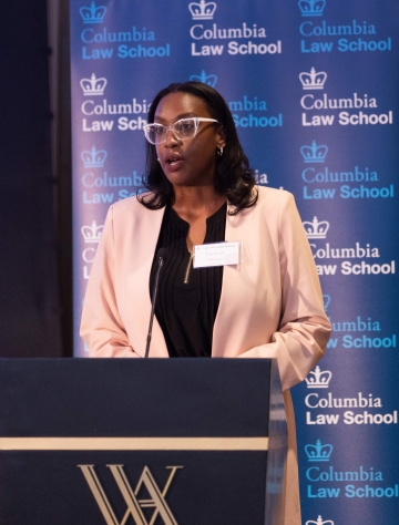 Women in glasses at a podium