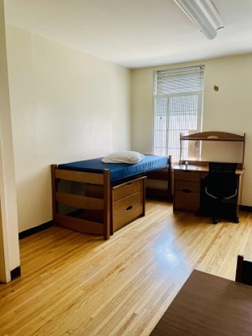 Image of a bed and desk in Watt Hall