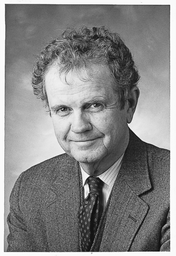 Black and white photo of Henry Monaghan in jacket and tie