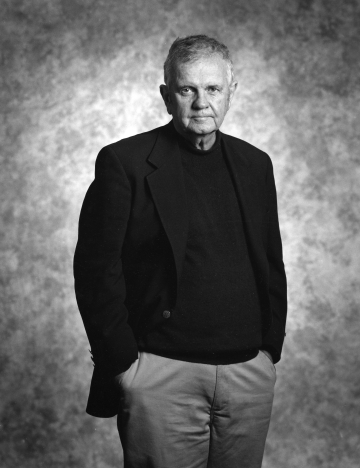 Black-and-white photo of Henry Monaghan in dark jacket and light pants