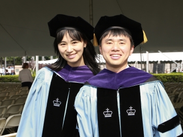 Heng Gong and Xiao Zhu in their graduation regalia